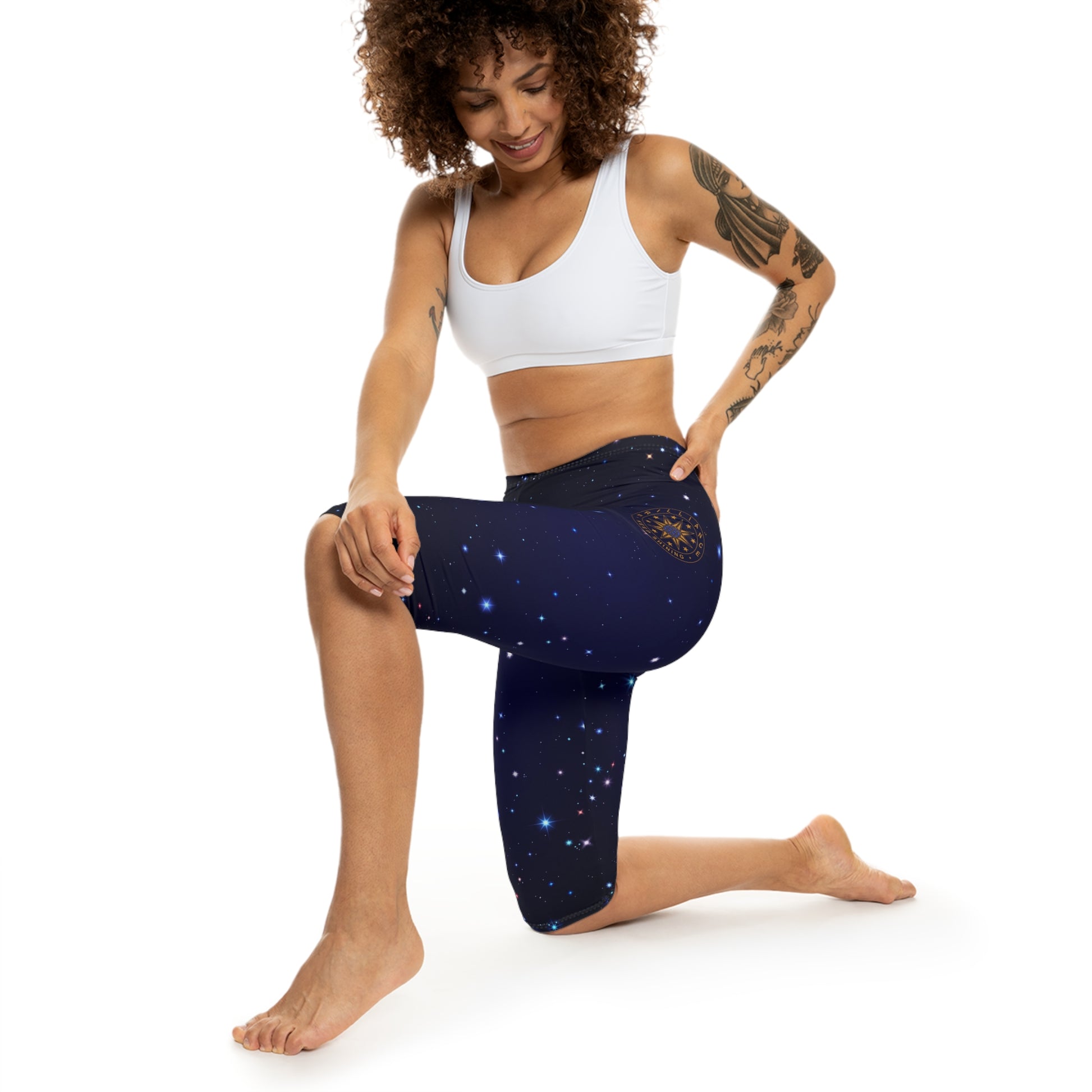 Brilliance Women’s Capri Leggings with Starry Night Print and Logo Left Side with Model Lunge Position